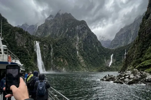 Waterfalls and dramatic cliffs seen during a Milford Sound cruise in Fiordland National Park
