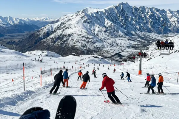 Skiers enjoying snowy slopes at The Remarkables ski field near Queenstown